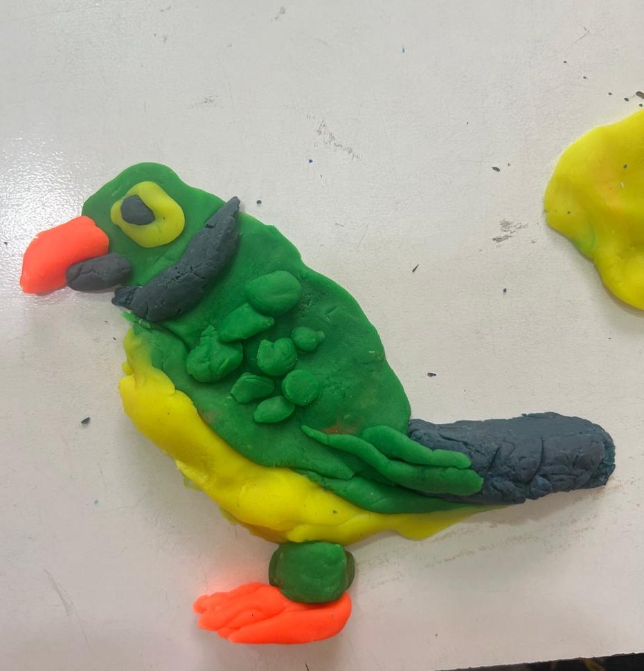 A colourful bird modelled from play-dough, made during a calming activity at home.