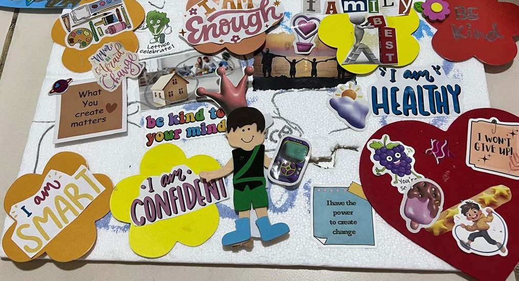 A coaching vision board covered with affirmation cut-outs about being smart, confident, healthy and kind.