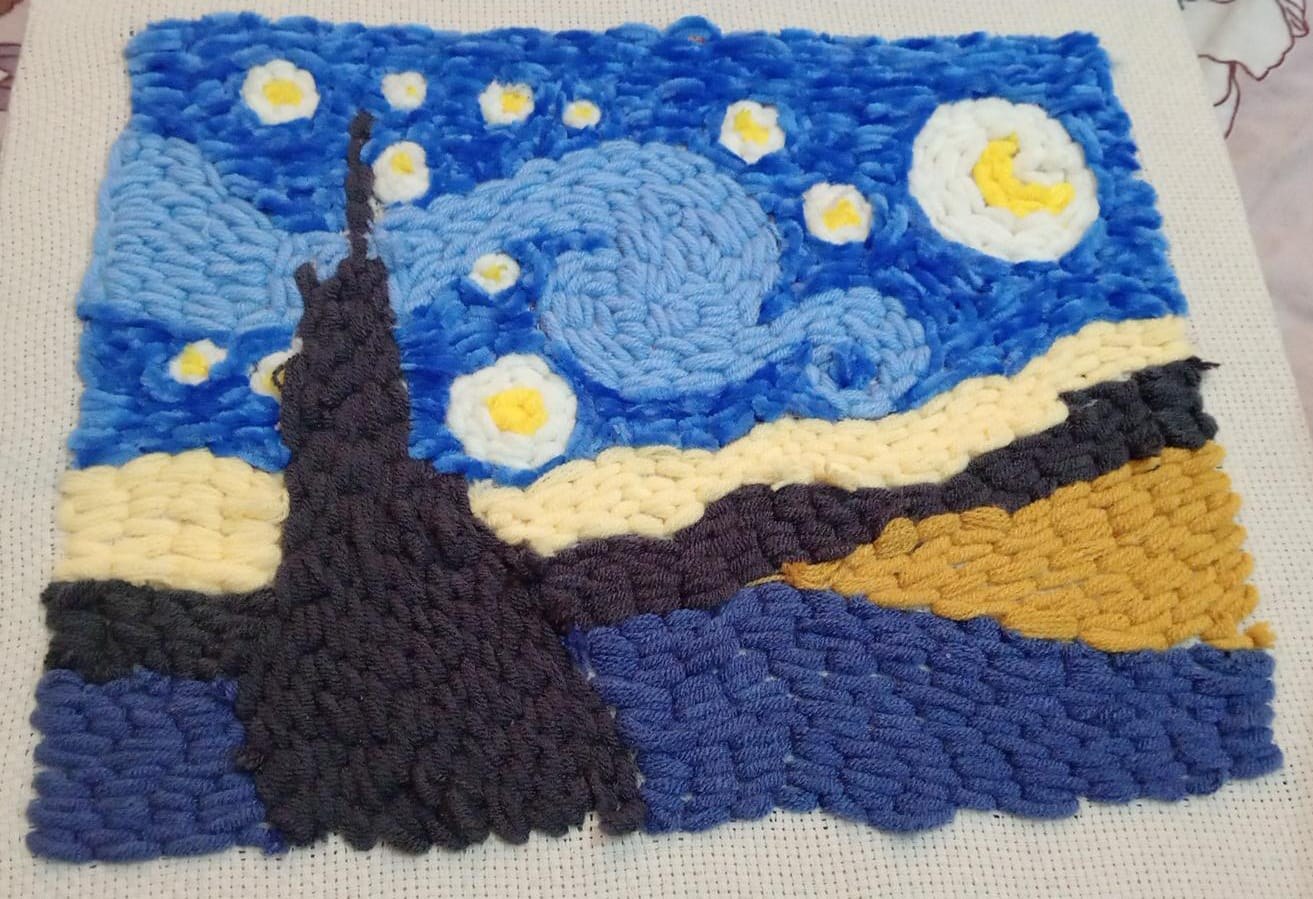 A handmade wool artwork of a starry night sky, given as a gift at the end of the coaching programme.