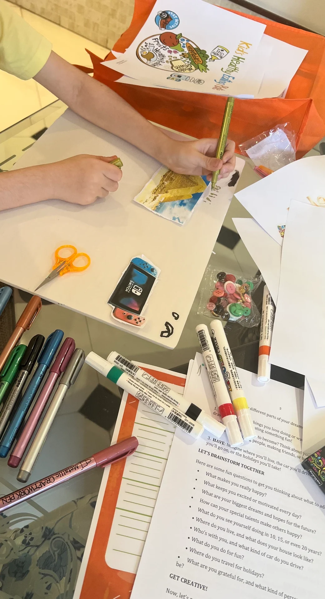 Hands working with drawing materials during a future-focused coaching activity.