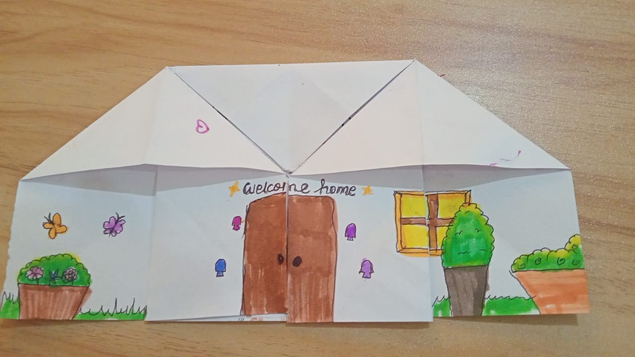 A folded paper house activity used in coaching, shown closed.
